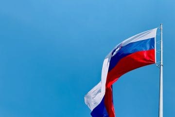 A red, white and blue flag flying in the wind