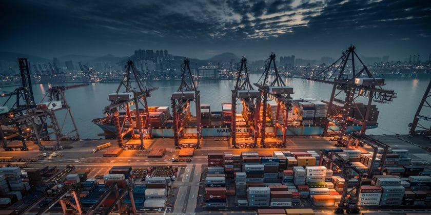 red and black cargo ship on dock during daytime