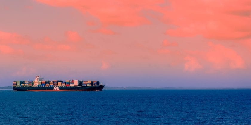 cargo ship on sea under cloudy sky during daytime