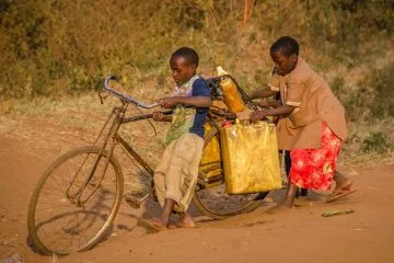 two kids using brown bike with cargo