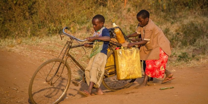 two kids using brown bike with cargo