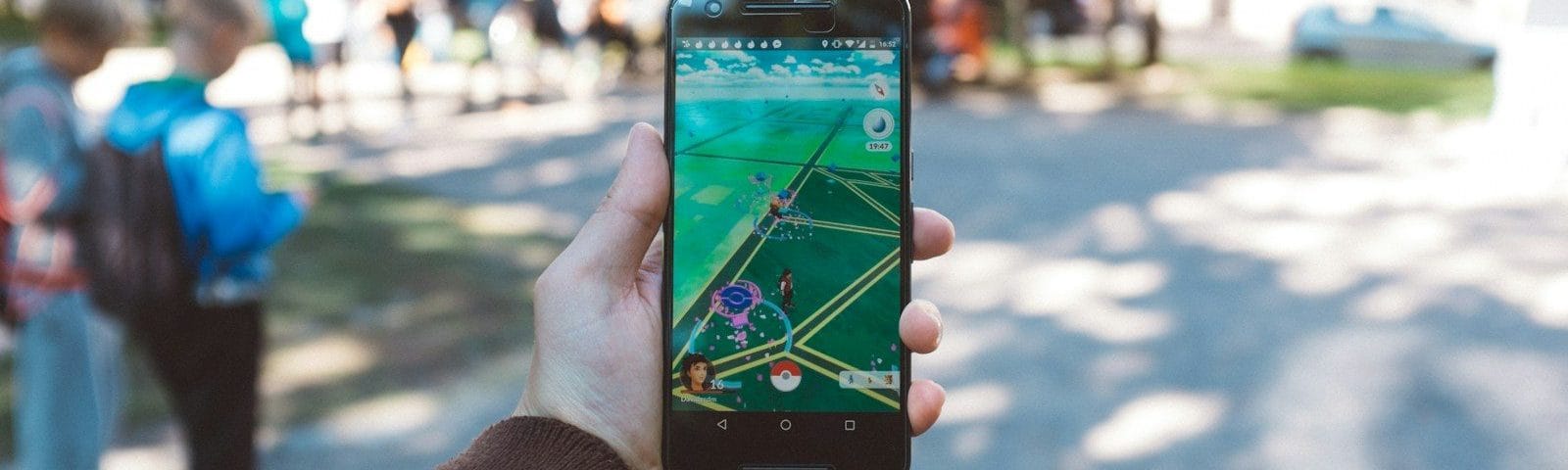 person playing Pokemon Go during daytime