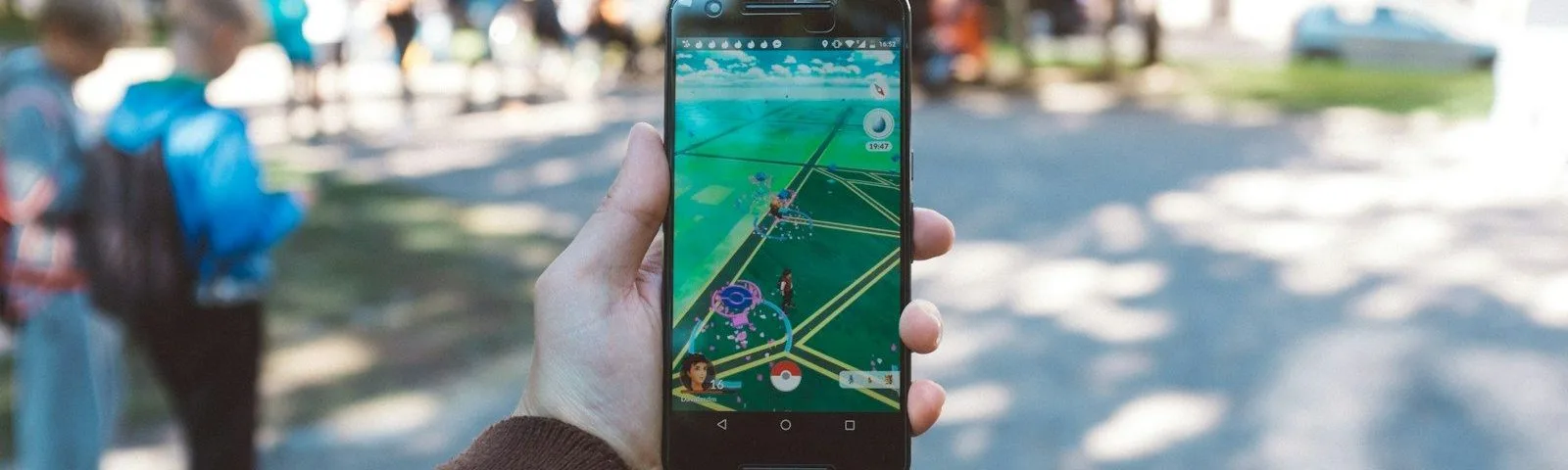 person playing Pokemon Go during daytime