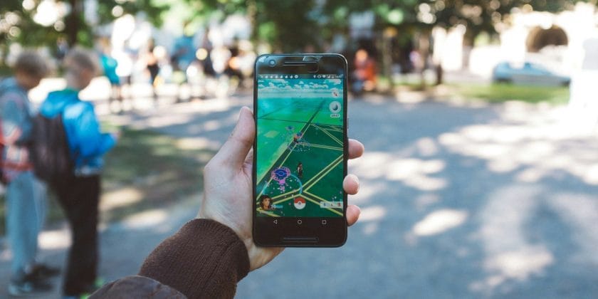 person playing Pokemon Go during daytime