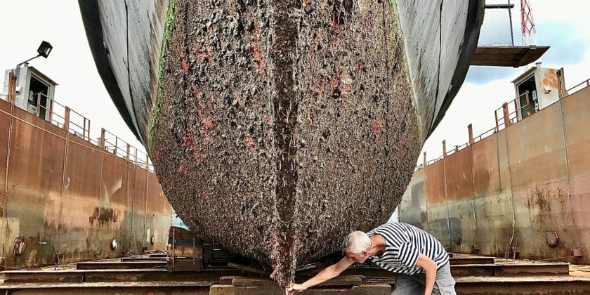 a man working on a large boat in a dry dock